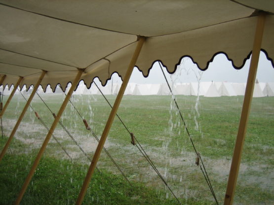Canvas tent with rainwater falling off the awning
