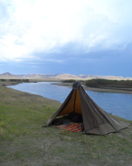 oilskin shelter on a flat landscape by a slow river