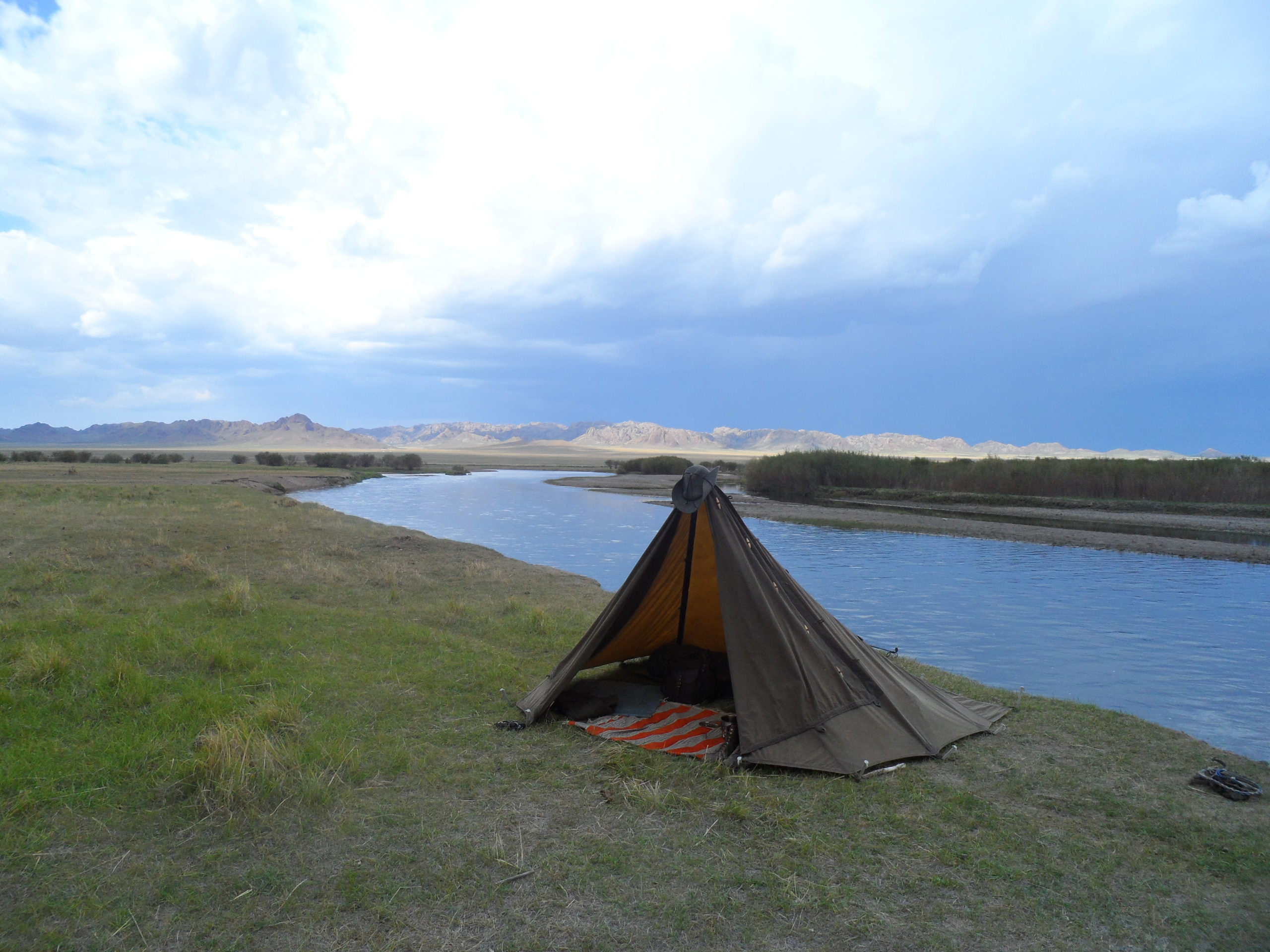 oilskin shelter on a flat landscape by a slow river