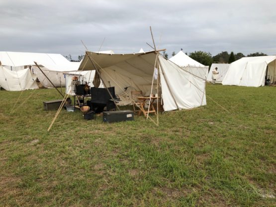 Baker style tent set up in green grass