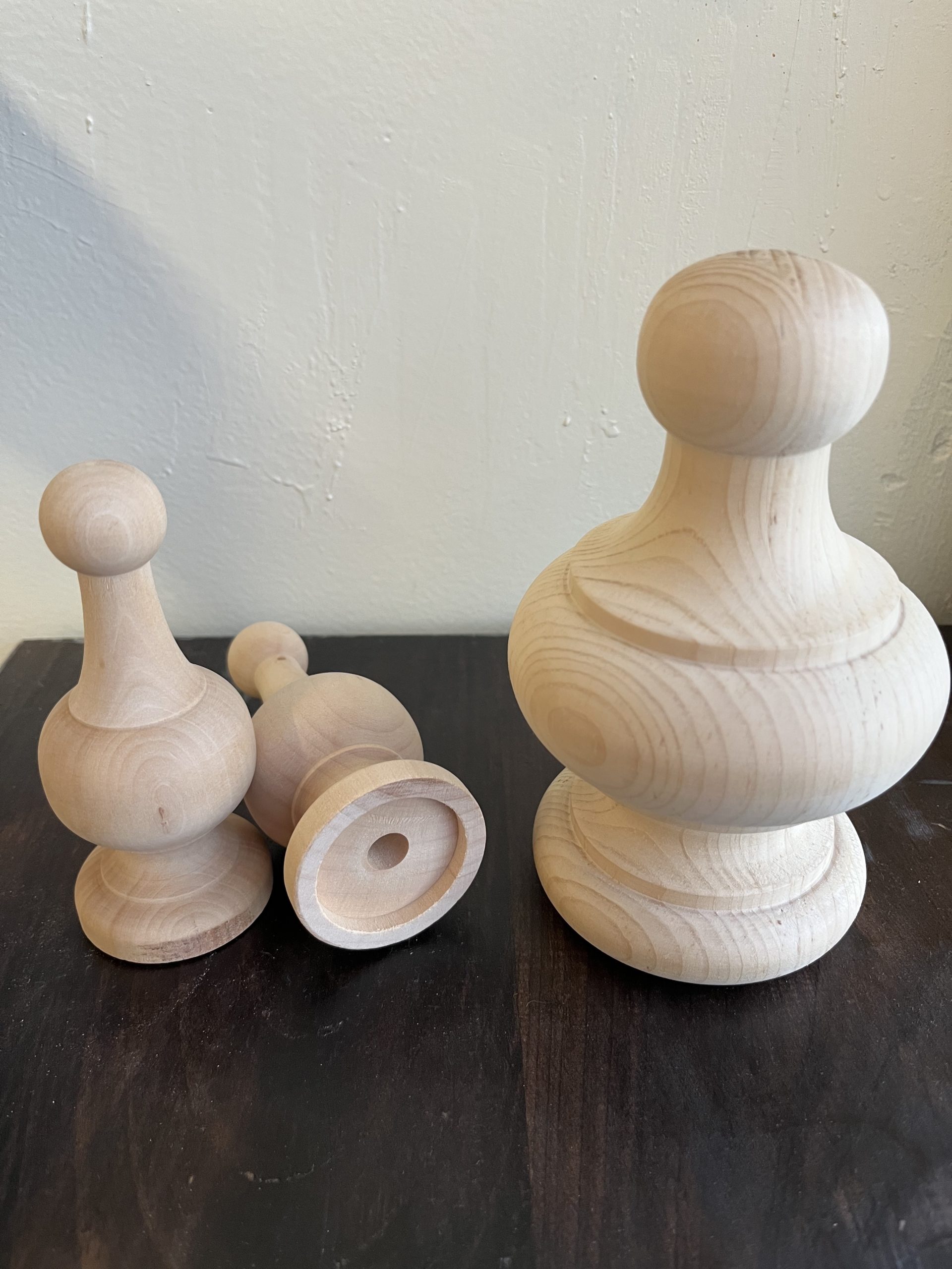 3 wooden objects on a dark table