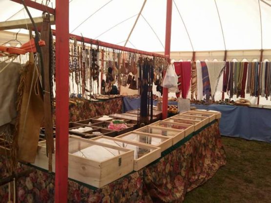 insode of a white canvas tent with bead display