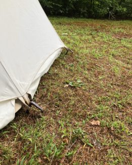 White canvas tent and metal stakes