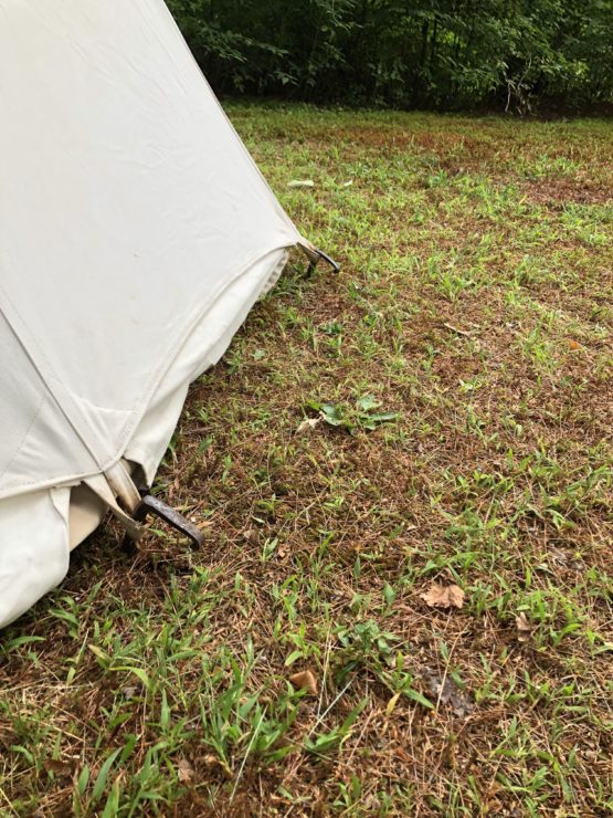 White canvas tent and metal stakes