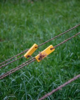 field of grass with ropes running across the field, with yellow rope tensioners